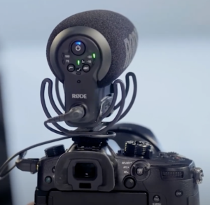 This is a photo of the Rode mic and the camera it is mounted on from the photographer's point of view. The power and setting of the mic are displayed. 